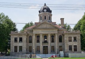 Multistory building with clock tower and covered porch