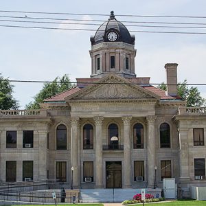 Multistory building with clock tower and covered porch