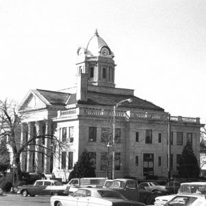 Two-story courthouse with dome clock tower and four columns