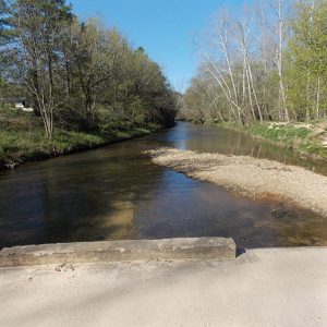 Bayou with gravel sandbar as seen from bridge