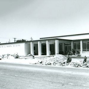 Single-story building with flat roof and covered porch on street