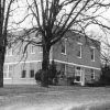 Two-story brick building with trees