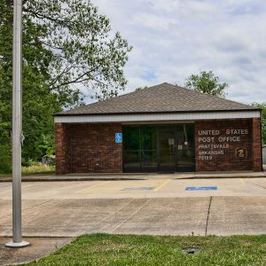 Single-story brick post office building on parking lot