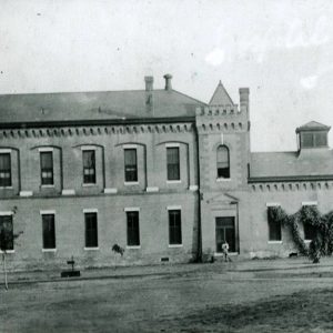 Multistory building with corner tower and single-story extension