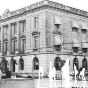 Three-story stone building with arched entrances and rows of windows