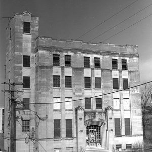 Car parked outside multistory building with tower