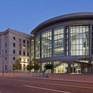 Five-story courthouse building with round entrance section on city street