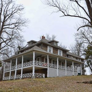 Multiple story cabin with balcony and covered porch on hill side