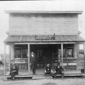 Four white men in hats outside "Ratcliff Arkansas post office" building