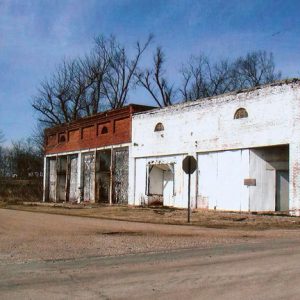 Abandoned brick storefronts on rural street corner