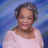 Older African-American woman smiling in pink dress