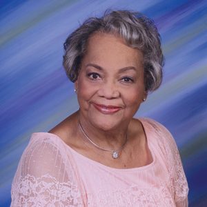 Older African-American woman smiling in pink dress