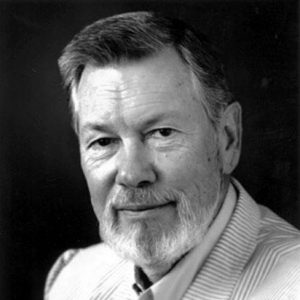 White man with beard and mustache in striped suit