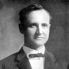 White man in suit and bow tie