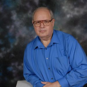 Older white man with glasses and blue shirt