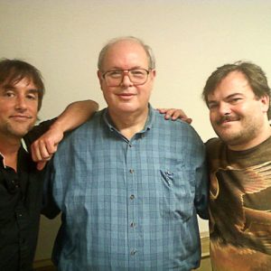 Three white men standing together smiling