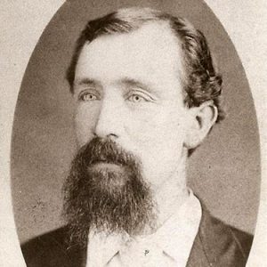 White man with beard in suit and tie