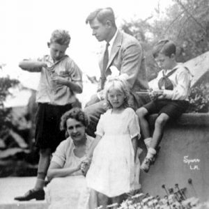 White man in suit with his wife, two sons, and daughter