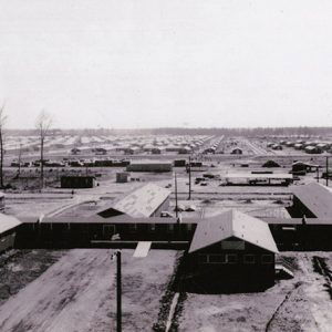 Single-story barracks buildings and surrounding land as seen from above