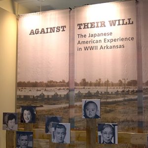 "Against their will the Japanese American Experience in World War Two Arkansas" display with photographs in museum