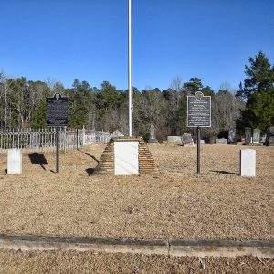 Flag pole with signs in cemetery