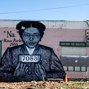 Mural featuring African American woman on a pink building