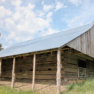 Wood barn with metal roof and gate