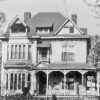 Multistory house with covered corner porch on street