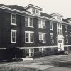 Multistory brick dormitory building with wheelchair ramp in front