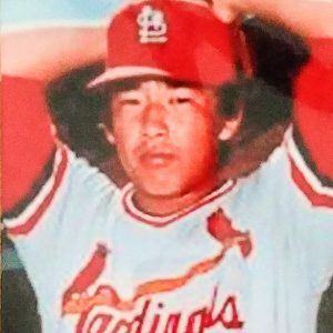 Japanese-American man in red and white uniform