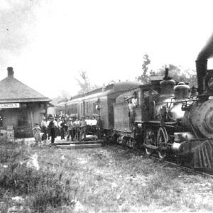 People boarding a steam locomotive at train station