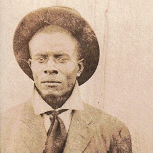 old faded photo of African-American man in hat and suit and tie