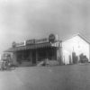 Single-story store with striped awning and gas pumps