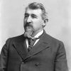 White man with beard in suit and tie