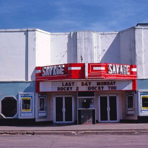 "Savage" theater building with marquee on street