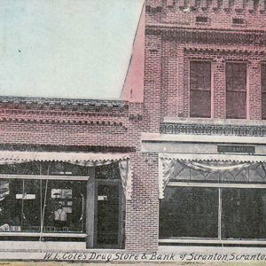 Brick storefront and two-story bank on street corner