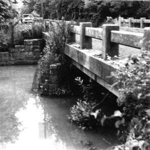 Concrete bridge with railings over creek