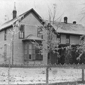 Two story building with wrought iron fence in front