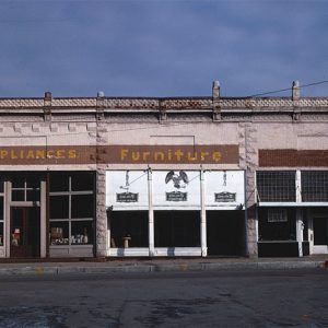 Brick storefront buildings with display windows on street