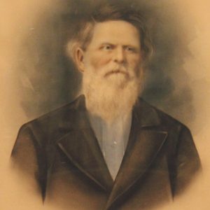 White man with long beard in suit jacket