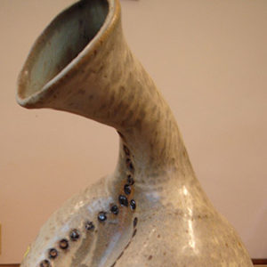 Close-up of jug with bent neck on display