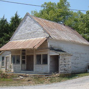 Abandoned store with awning on grass