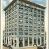 Multiple story city building on postcard