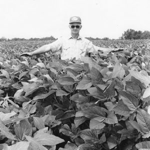 White man standing in field of plants