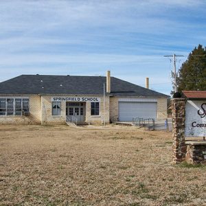 Single-story "Springfield School" building with garage bay