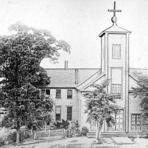 Brick church with steeple and outbuildings