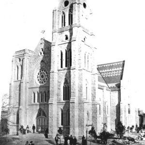 Stone church with bell tower and rose window