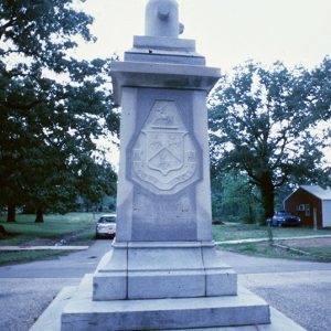 Engraved shield on stone monument with pedestal