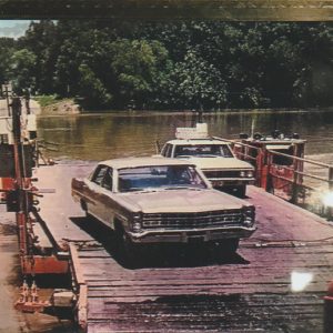 Two cars driving off river ferry