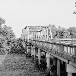 Steel arch bridge with concrete platform and supports